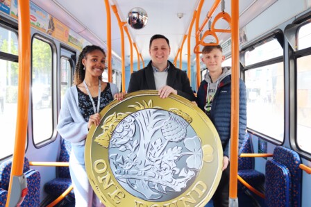 Mayor Houchen with a giant £1 on a bus